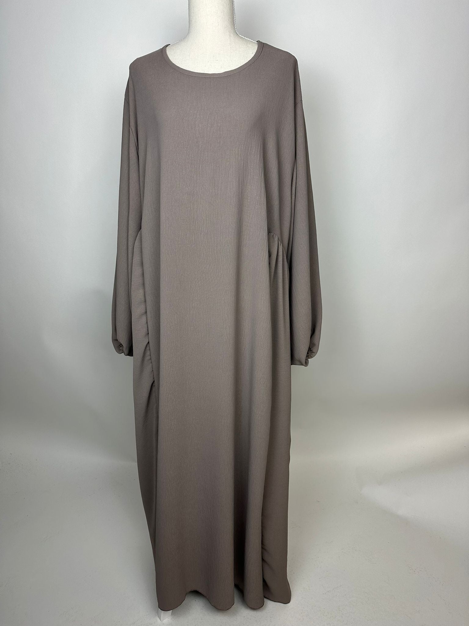 Taupefarbene Abaya aus Jazz Stoff mit weitem Fall, seitlicher Raffung und Rundhalsausschnitt, Vorderansicht