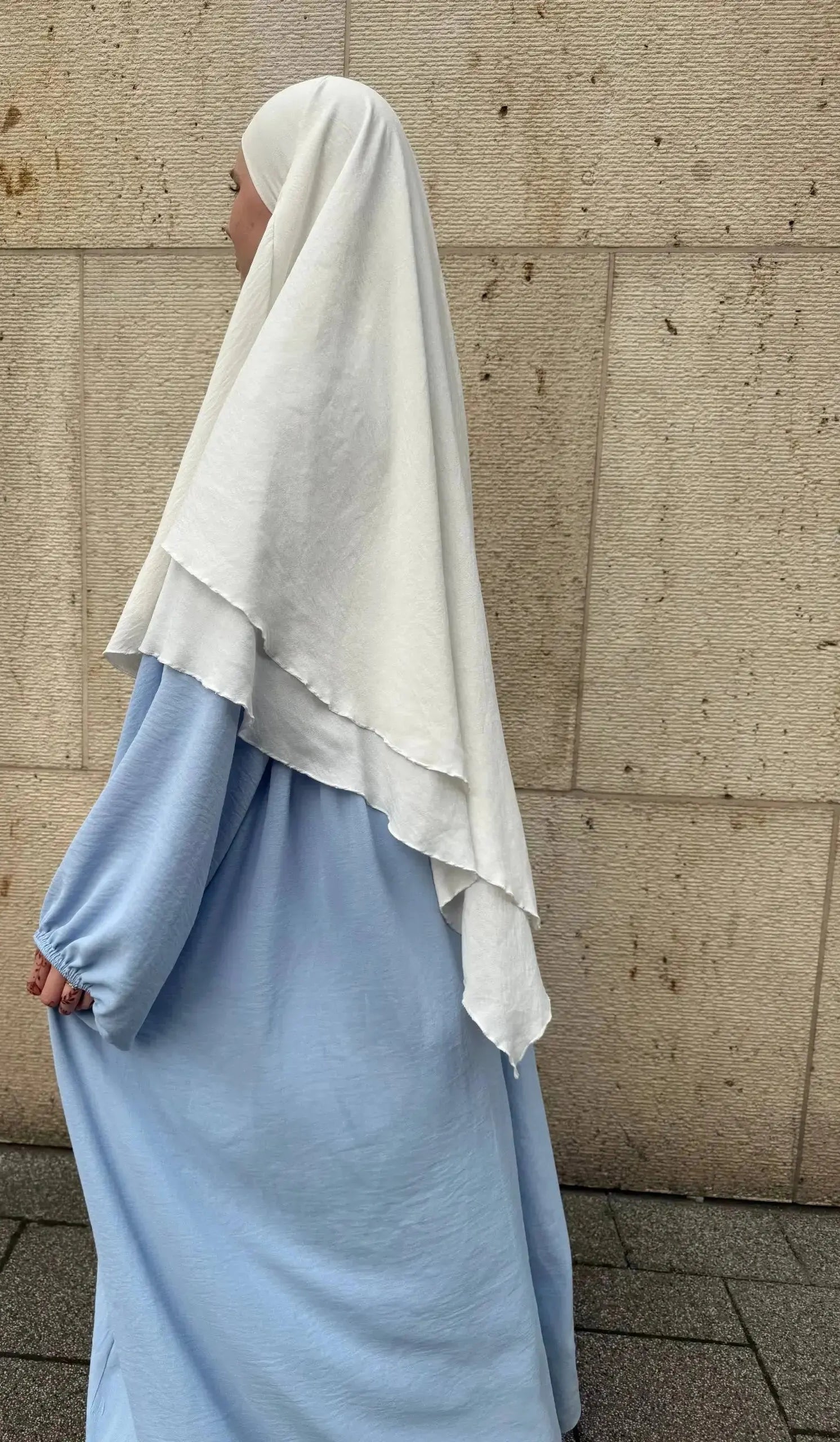 abaya aus hellblauem jazzstoff, weit geschnitten mit elastischem ärmelbund, seitenansicht unter weißem khimar