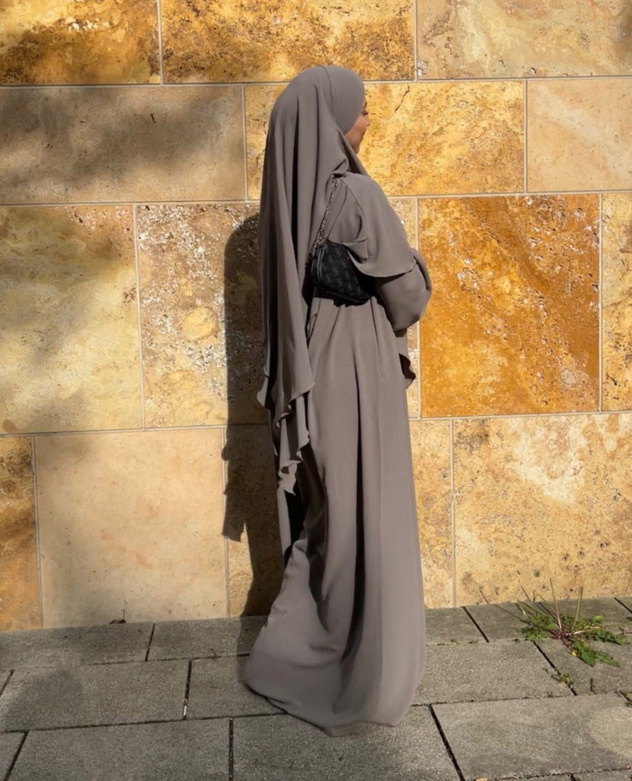 Ein zweilagiger Khimar und eine Abaya mit Ballonärmeln, frontale Ansicht, aus fließendem Material.