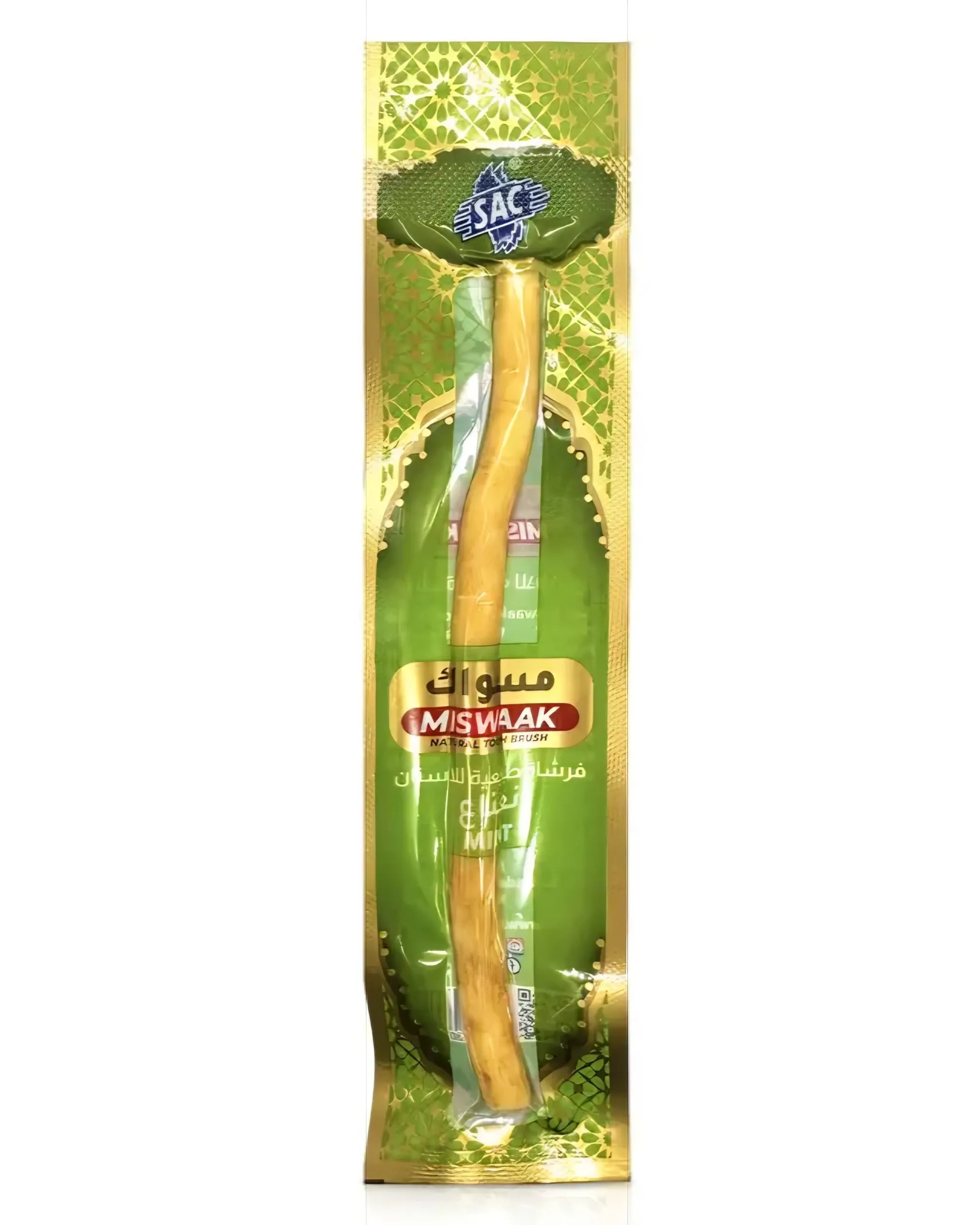 Beigefarbene Miswak Naturzahnbürste aus Holz liegt in grüner Minz-Verpackung mit arabischer Aufschrift, Vorderansicht
