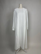 Weiße Open-Abaya Dubai aus Medina-Seide mit passendem Unterkleid ist in Vorderansicht zu sehen.
