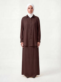 Schokobrauner Zweiteiler mit langärmeligem Hemd, Knopfleiste und bodenlangem Unterkleid, Frontalansicht.