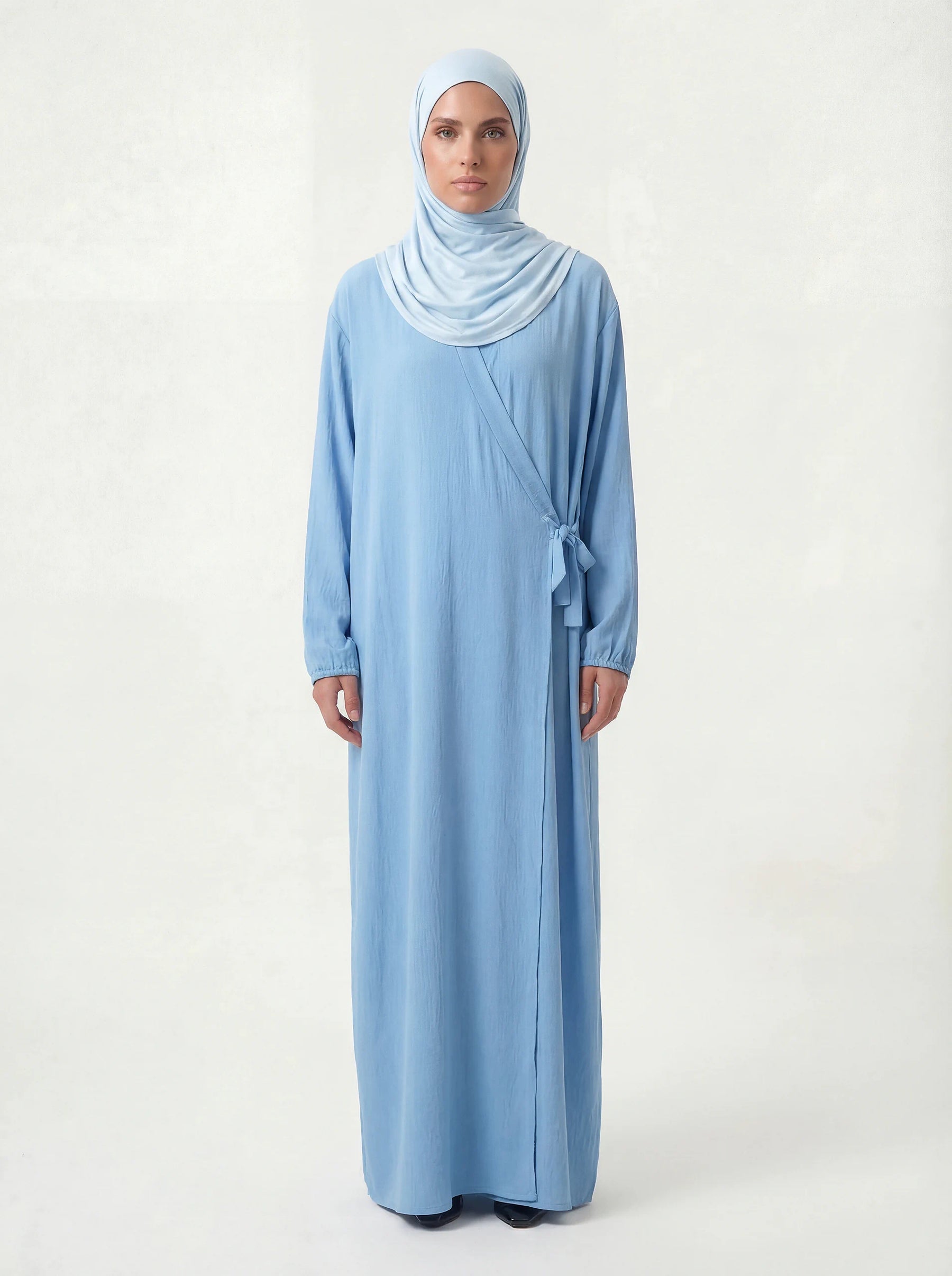 Hellblaue Modest Abaya aus Jazz-Stoff im Wickelstil mit Ballonärmeln und Bindeschleife, Vorderansicht, Hijab-Style